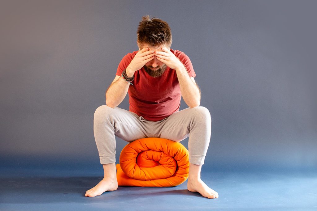 Man practicing nada yoga a technique that benefits concentration.