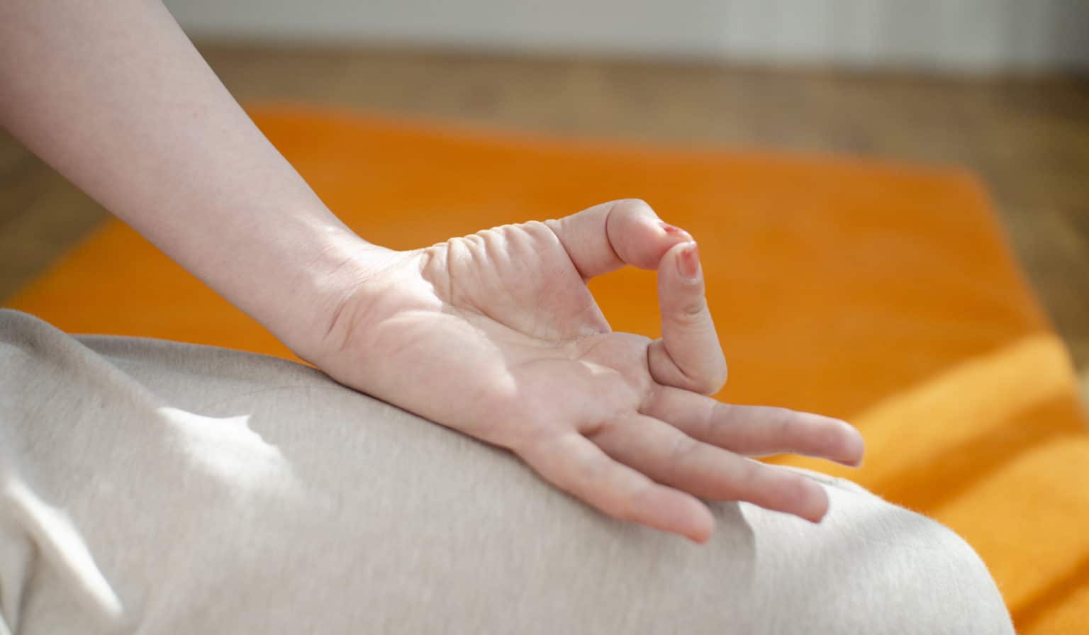 Woman doing hand-mudra while meditating.