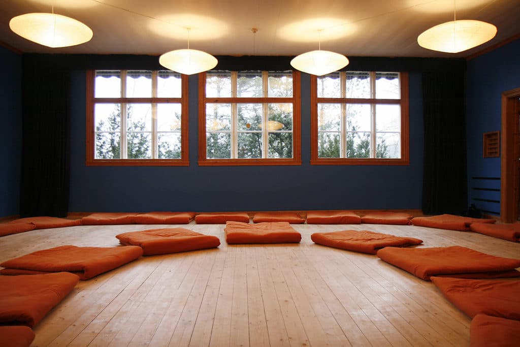 Orange yoga mats in yoga room