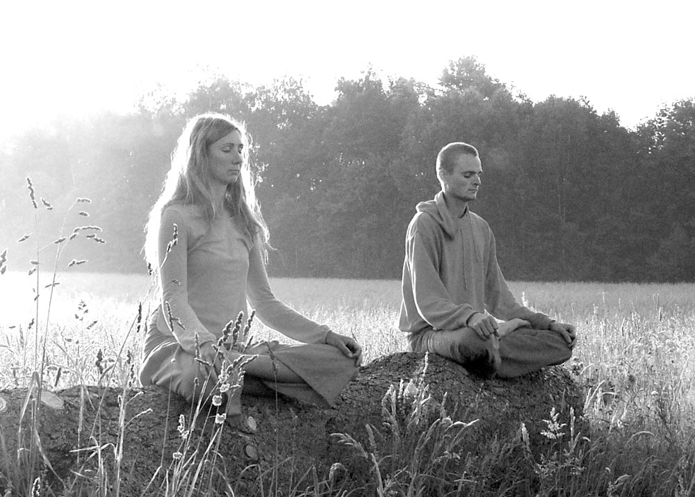 Man and woman sitting in the lotus pose.