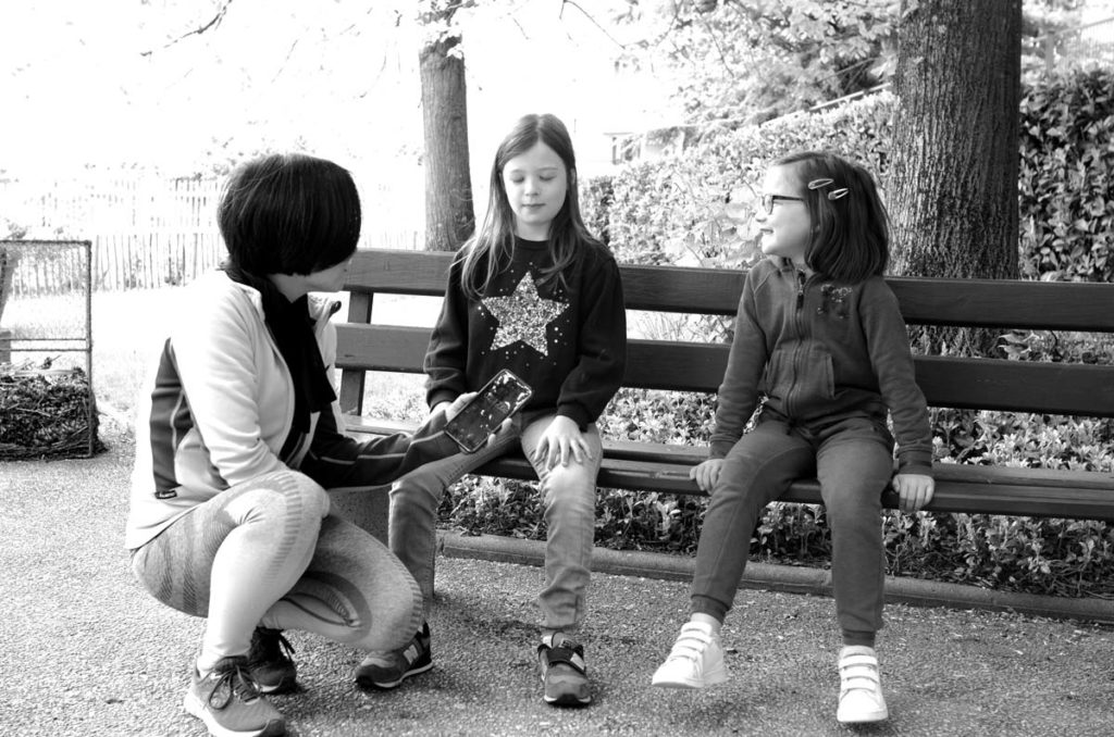 Girls training immobility in a park.