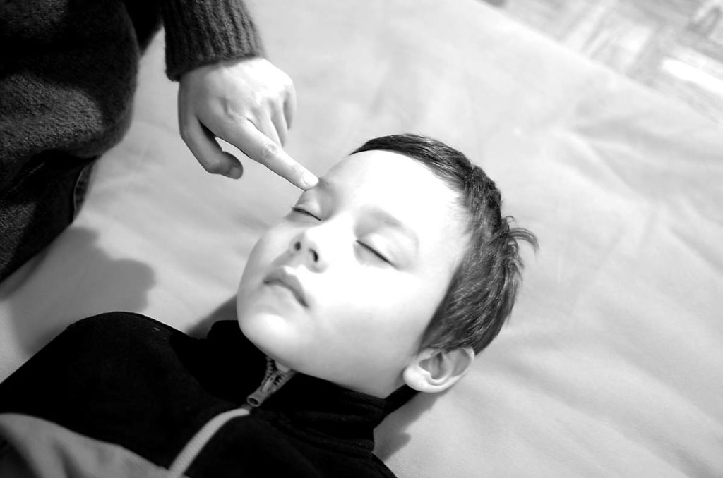 Mother touching her son during rotation during rotation of consciousness.