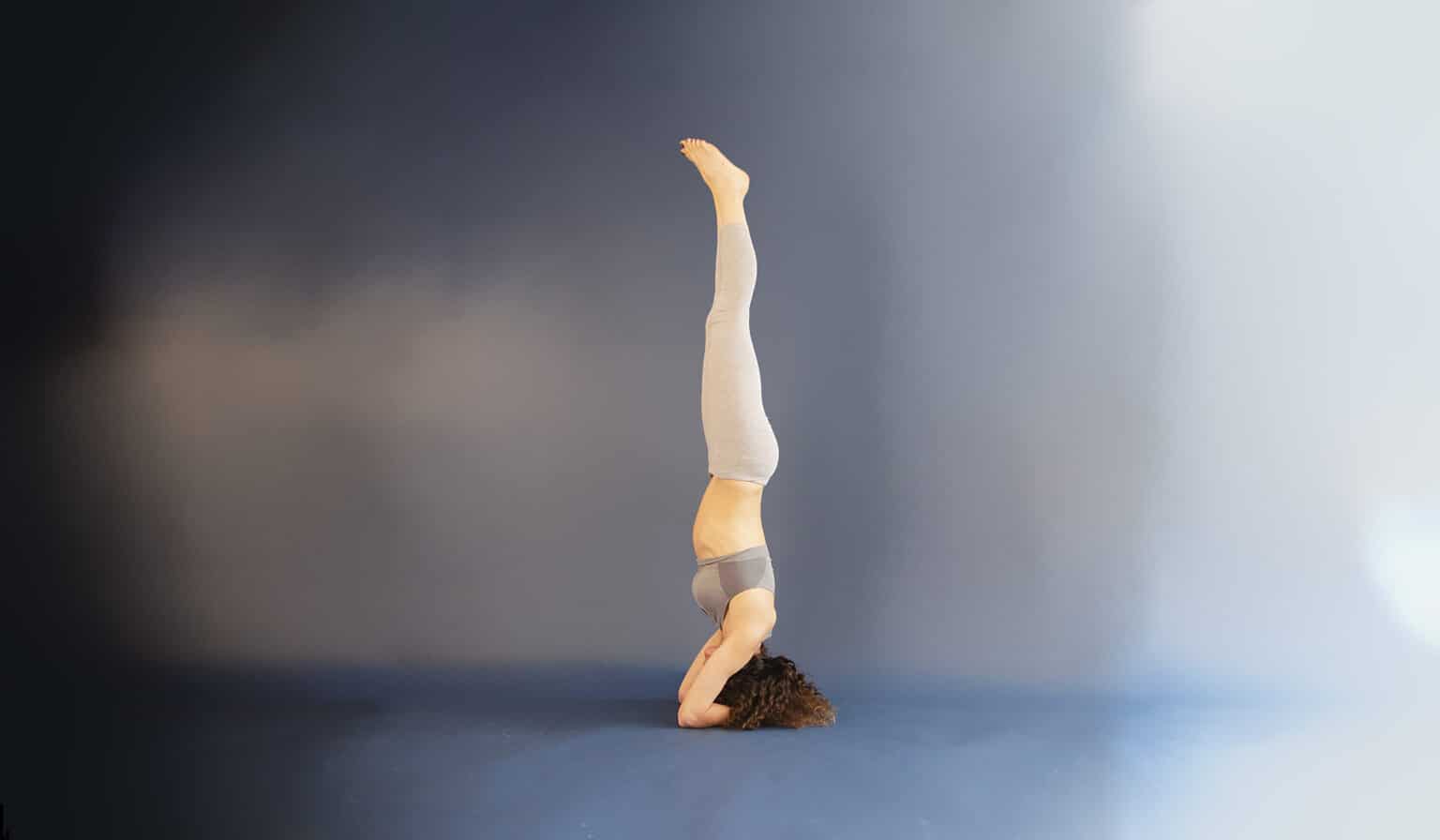 Woman who has learnt to do the headstand without a wall.