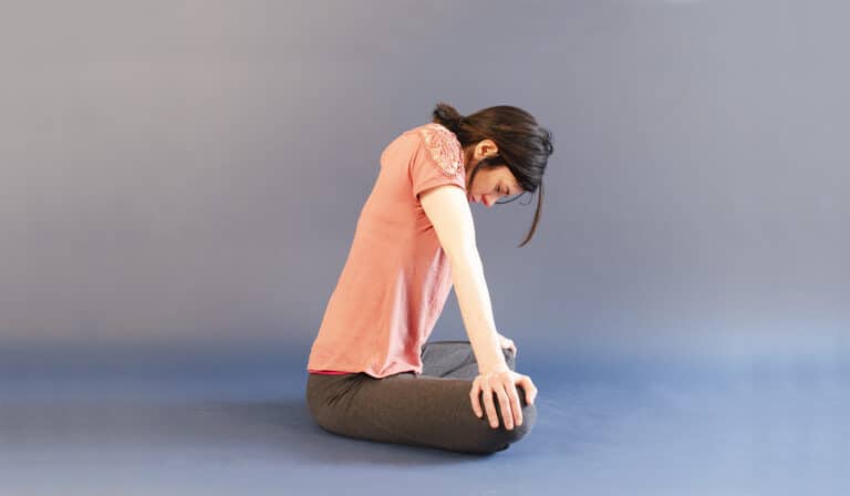 Woman in jalandhara bandha after bhastrika pranayama.